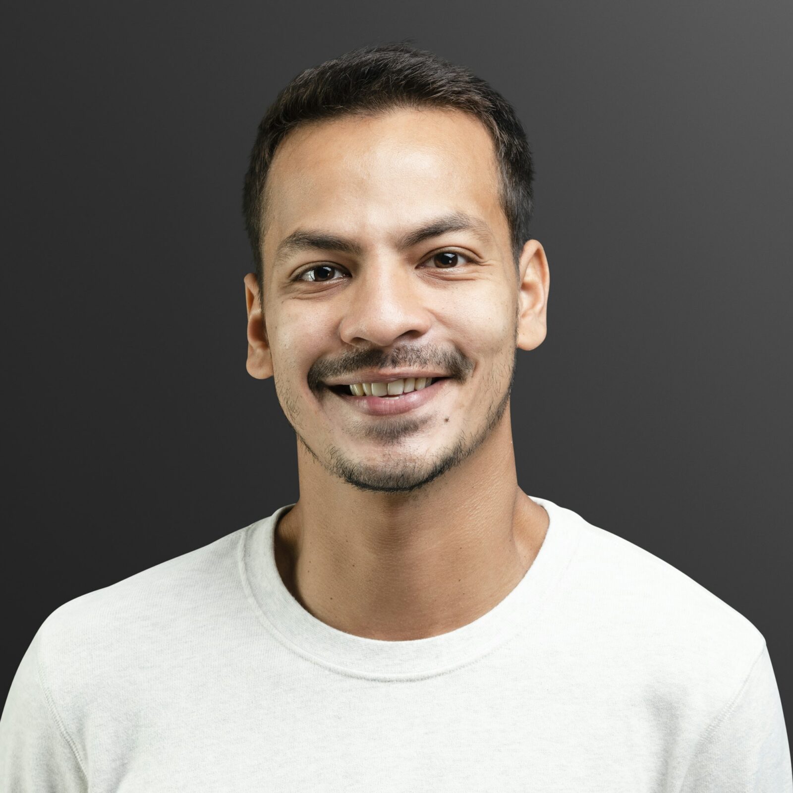 Smiling man in white long sleeve tee portrait